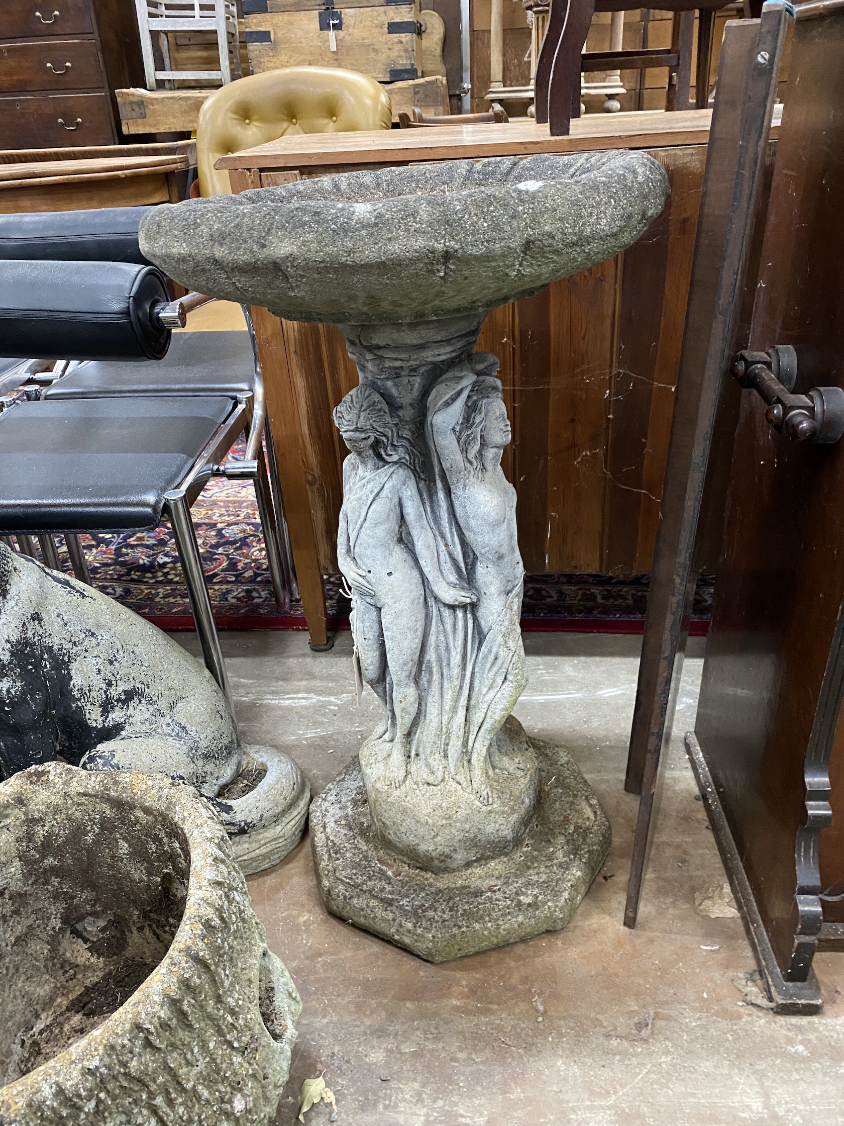 A reconstituted stone circular 'The Three Graces' bird bath, diameter 48cm, height 84cm